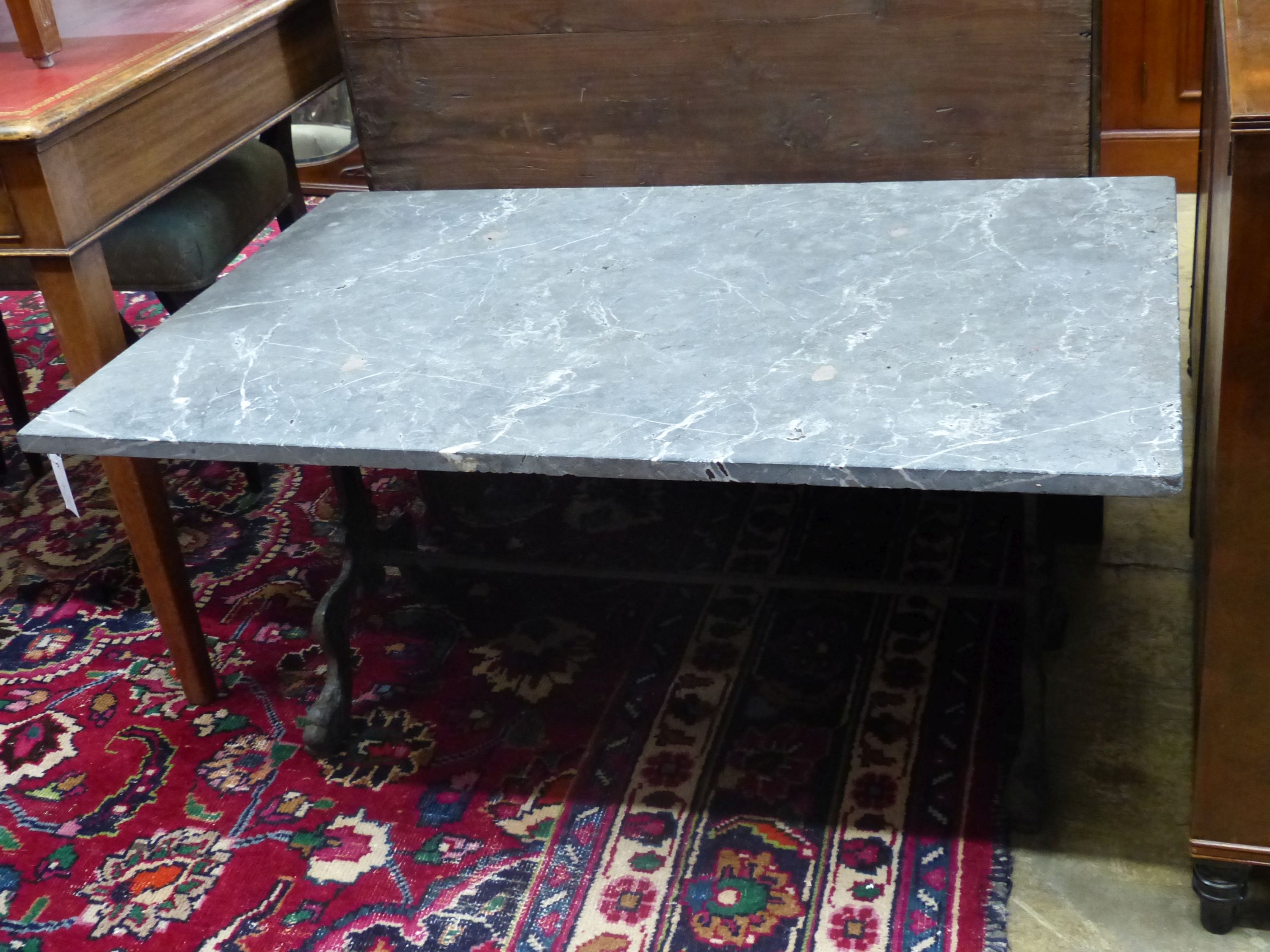 A rectangular marble top cast iron coffee table, width 108cm, depth 71cm, height 50cm